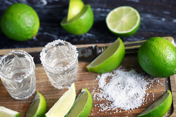 Selective focus. Glasses of tequila with salt and lime. White tequila.