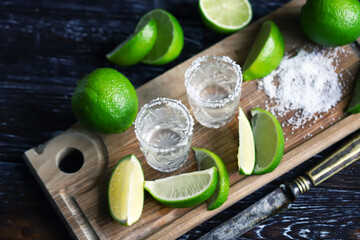 Selective focus. Glasses of tequila with salt and lime. White tequila.