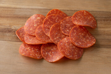 Pepperoni Slices on a Cutting Board - obrazy, fototapety, plakaty