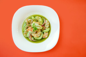 Aguachile plate, delicious Mexican plate with shrimps, green sauce, cucumber, lemon, and avocado.