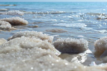 Fototapeta na wymiar Close up of salt background. Natural salt. Dead Sea salt mineral natural formations. Salt crystals from Dead sea. View of Dead Sea coastline. Texture of Dead sea. Salty seashore rocks