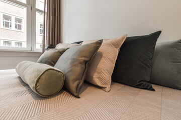 Emerald green pillows and gray linens on the bed