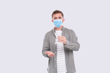 Fototapeta na wymiar Man Using Hands Antiseptic Wearing Medical Mask Isolated. Hands sanitizer