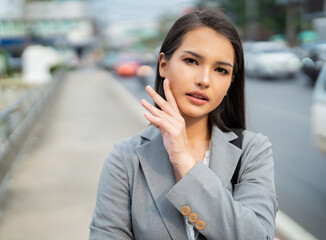 Beautiful face of an Asian business woman she is outdoors