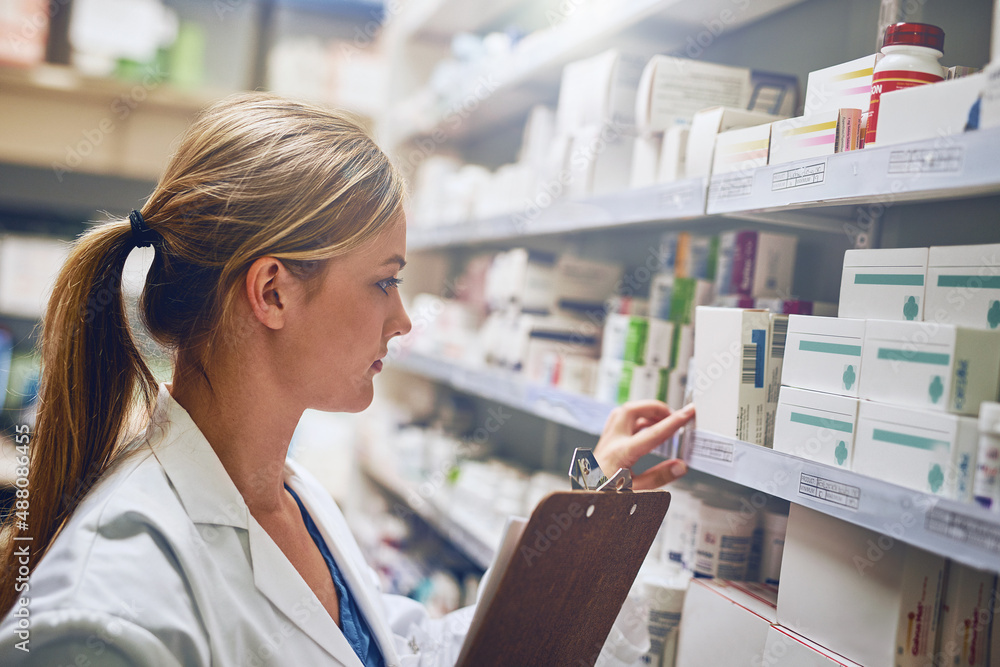 Poster shell change your live for the better. shot of a pharmacist looking at medication on a shelf.