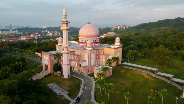 UMS Mosque or also known as Pink Mosque in Kota Kinabalu, Sabah, Malaysia. Aerial view with a drone flying in orbital motion
