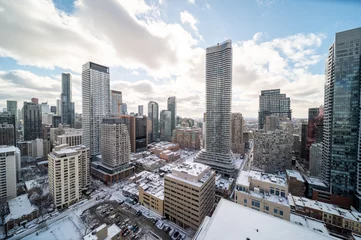 Foto op Plexiglas Downtown Toronto Younge and Wellesley st in the winter time snow on buildings blue skies  © contentzilla