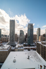Downtown Toronto Younge and Wellesley st in the winter time snow on buildings blue skies 