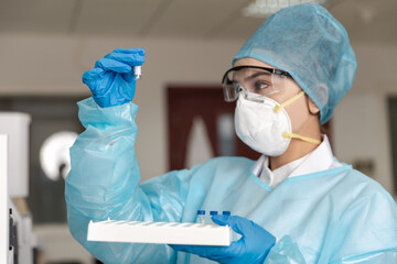 Female scientist looking at the scientific sample in the laboratory