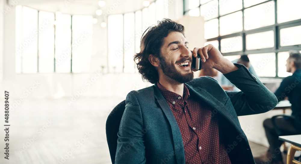 Poster What the client wants the client gets. Shot of a young businessman using a cellphone in a modern office.