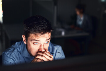 Oh no this cant be happening at this time. Cropped shot of a young attractive businessman working late in the office. - obrazy, fototapety, plakaty
