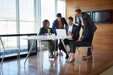 Gathered in the boardroom. Shot of a group of corporate businesspeople working in the boardroom.