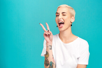 Fill the world with happiness. Studio shot of a confident young woman making a peace gesture against a turquoise background. - Powered by Adobe