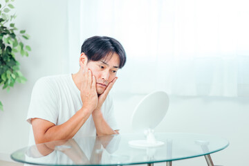 肌に悩む男性（ヒゲ・考える）
