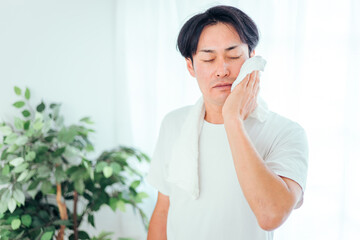 洗顔後タオルドライする男性
