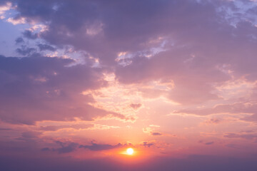 Fototapeta premium beautiful dark orange sky in the evening and the clouds at sunset. At dawn, the sun shines through the clouds. natural