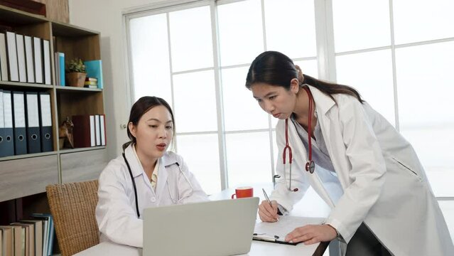 4k 50fps,  an Asian female medical student wearing a white shirt  ask for advice. about the sickness of the patient and the doctor's teacher in the office of the hospital