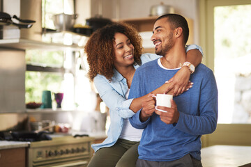 Honey, youre the best. Shot of a happy young couple feeling relaxed in the at home.