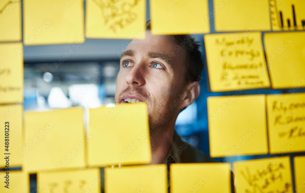 Aufkleber Sometimes the better ideas can be found outside the box. Shot of a young man having a brainstorming session with sticky notes at work.