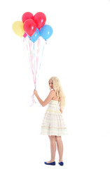
Full length portrait of blonde girl wearing party dress, holding bunch of colourful balloons. Isolated on white studio background