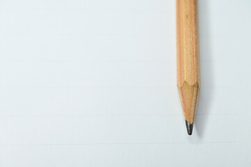 wooden pencil on white paper