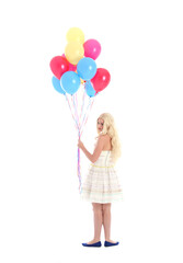 Fototapeta na wymiar Full length portrait of blonde girl wearing party dress, holding bunch of colourful balloons. Isolated on white studio background