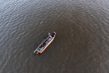 Small fisherman activity in Selat Panjang City , Riau Province at Sunset.  Small fishing business is dominant live hood in coastal area in Riau Province, Indonesia. 
