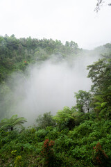 Fototapeta na wymiar Clouds in Tumpak Sewu waterfall, Java, Indonesia