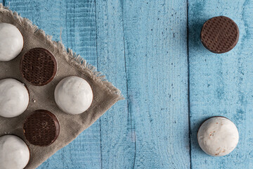 Homemade cookies with nuts, chocolate and milk on a wooden table and art background. Breakfast. Close.