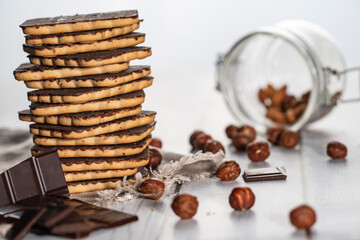 Homemade cookies with nuts, chocolate and milk on a wooden table and art background. Breakfast. Close.