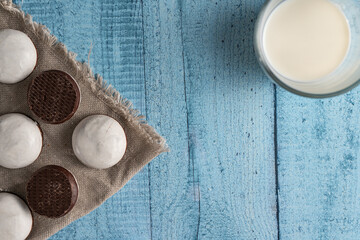 Homemade cookies with nuts, chocolate and milk on a wooden table and art background. Breakfast. Close.