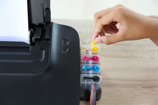 Close up hand pull ink tank lid on printer on the office desk for replace cartridges or refill ink Concept of copier or photocopier workplace equipment for scanning paper or copy document