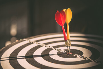 Bullseye target goal or dartboard has dart arrow throw hitting center shooting for financial...
