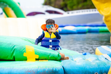 Obraz na płótnie Canvas cute boy playing on the water play park