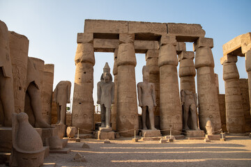 Columns and statues in the courtyard of Ramses II of the Luxor Temple. Luxor (destroyed Thebes)....