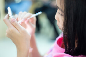 cute little girl playing gadget