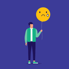 Young Man Holding And Looking At His Yellow Balloon With Sad Face. Negative Emotion.