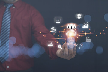 Businessman holding light bulb with cloud computing on hands with a business icon with copy space. Security database and digital networking, the technology of business to the future concept.