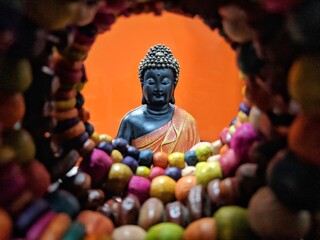 Buddha in a meditation pose, under protection of the king of nag - Mukalinda. Figure isolated on a black background.
