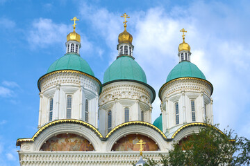 Fototapeta na wymiar Domes of the ancient Assumption Cathedral against the blue sky. Astrakhan Kremlin, Russia