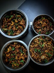 Gobi Manchurian or Gobi 65 in bowl at black concrete background. Gobi Manchurian is Indian Chinese cuisine dish with cauliflower, onion, soy sauce,Gobi Manchurian dry - Popular street food,india