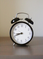 retro alarm clock is on the bedside table