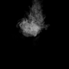 A swirling vapor isolated on a black background for overlaying on your photos. Fragment of vertical steam