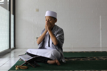 Muslim children pray peacefully and quietly in the mosque. Ramadan kareem concept. 
