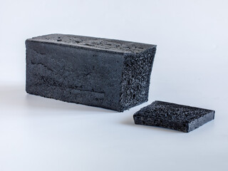 Black coal toast bread isolated on white background with copy space, chopped, side view, horizontal, selective focus