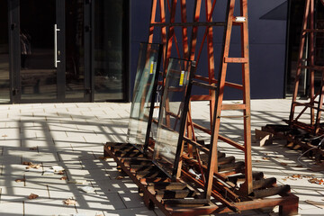 double-glazed windows on an iron stand stand outside