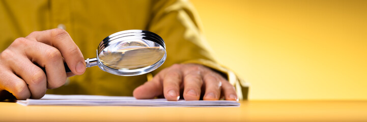 Lawyer Examining Paper Using Magnifier Glass