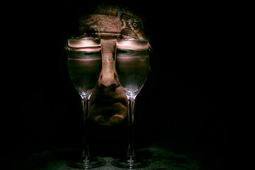 Surrealistic illustration in the style of Salvador Dali with the human face looking through glasses of water