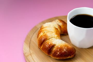fresh pastries and coffee on pink background, top view, breakfast concept