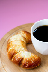 fresh pastries and coffee on pink background, top view, breakfast concept